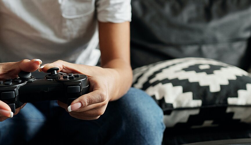 Menina jogando videogame em sala de estar 