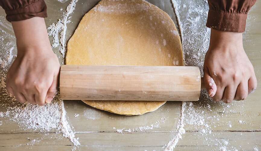 Chef abre massa com um rolo de cozinha
