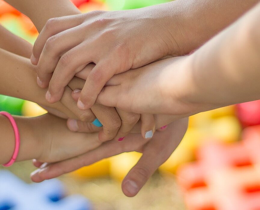 Mãos de crianças juntas.