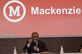 Roberto Brasileiro sentado à mesa discursando