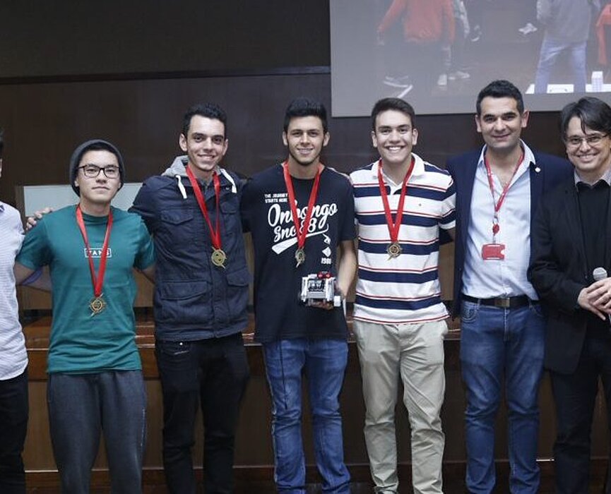 Equipe vencedora com o professor de Engenharia e o representante da empresa Festo.