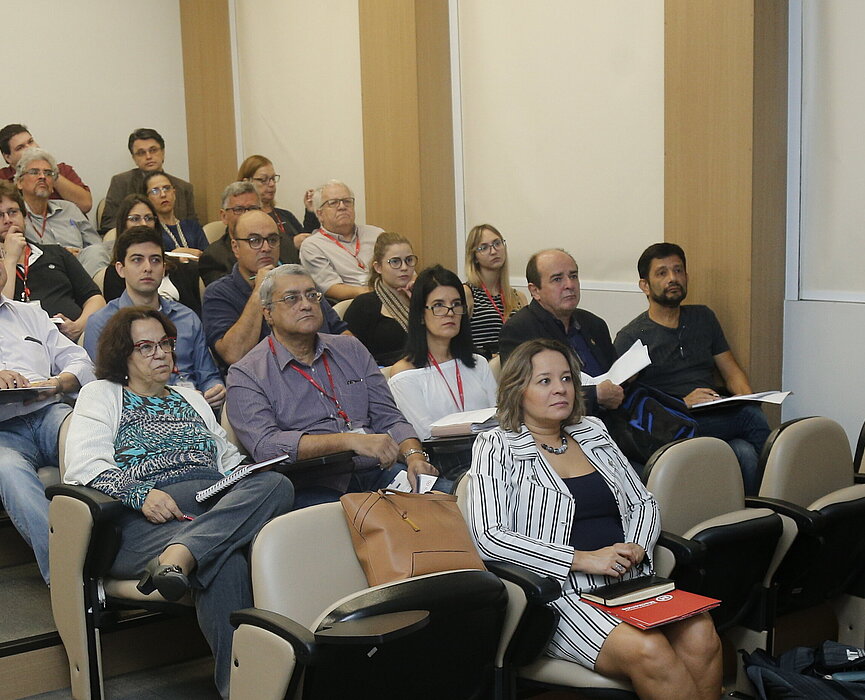 Platéia sentada nas cadeiras, ouvindo o palestrante da Coventry University.