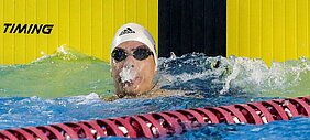 Daniel Dias cuspindo água ao final da prova dos 50m livre.