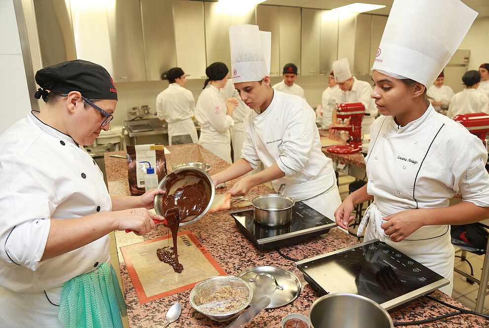 Alunos cozinhando durante a prova.