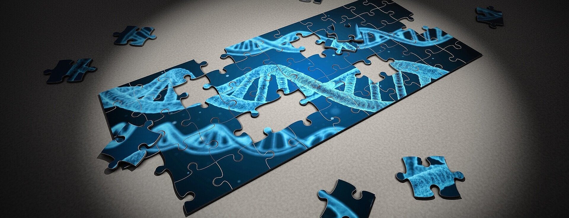 imagem de um quebra-cabeça semimontado com o desenho de um DNA em tons azuis