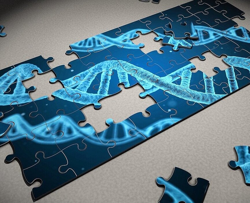 imagem de um quebra-cabeça semimontado com o desenho de um DNA em tons azuis