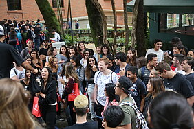 Novos alunos no campus recebendo brindes.
